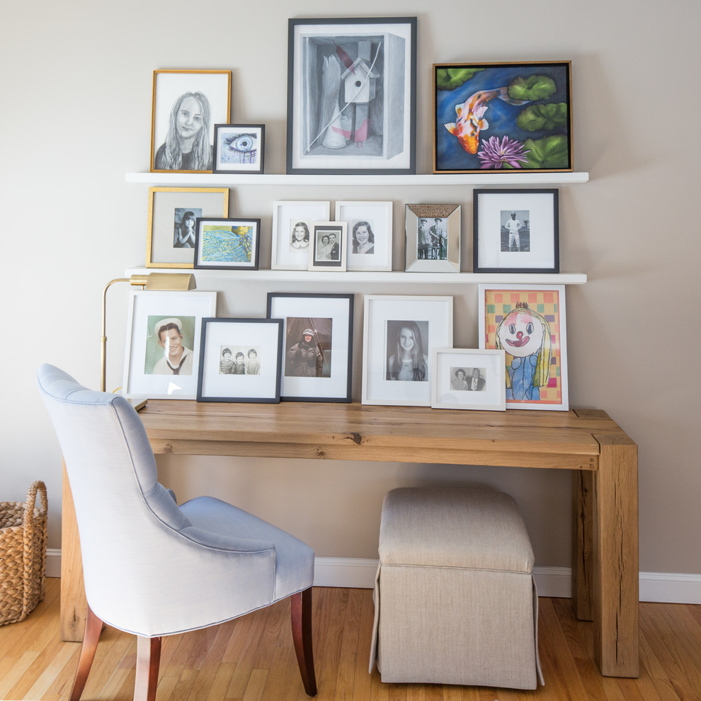 Example of a large farmhouse freestanding desk medium tone wood floor home office design in Boston with beige walls