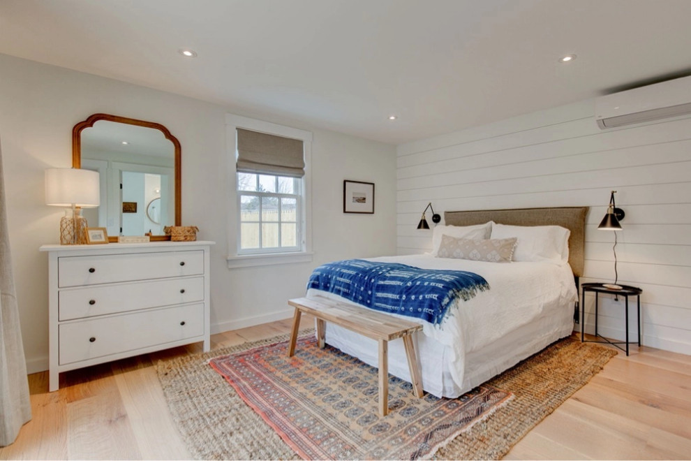 Design ideas for a nautical bedroom in Boston with light hardwood flooring.