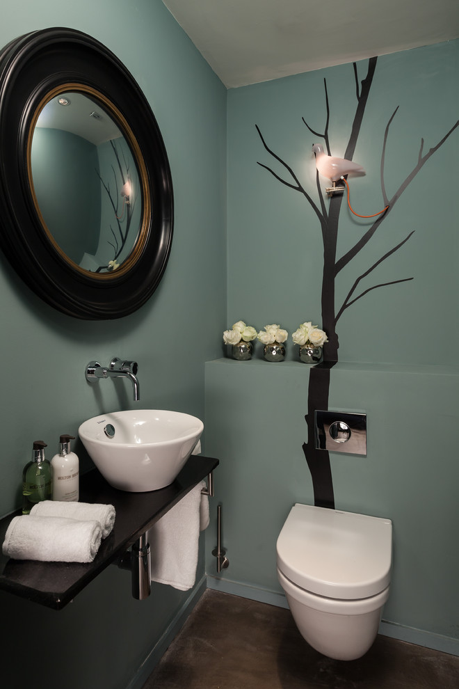 Inspiration for a contemporary powder room in Other with a vessel sink and blue walls.
