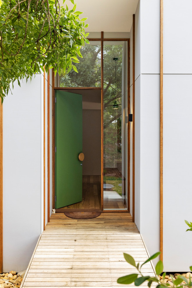 Idées déco pour une porte d'entrée contemporaine de taille moyenne avec un mur blanc, un sol en bois brun, une porte simple et une porte verte.