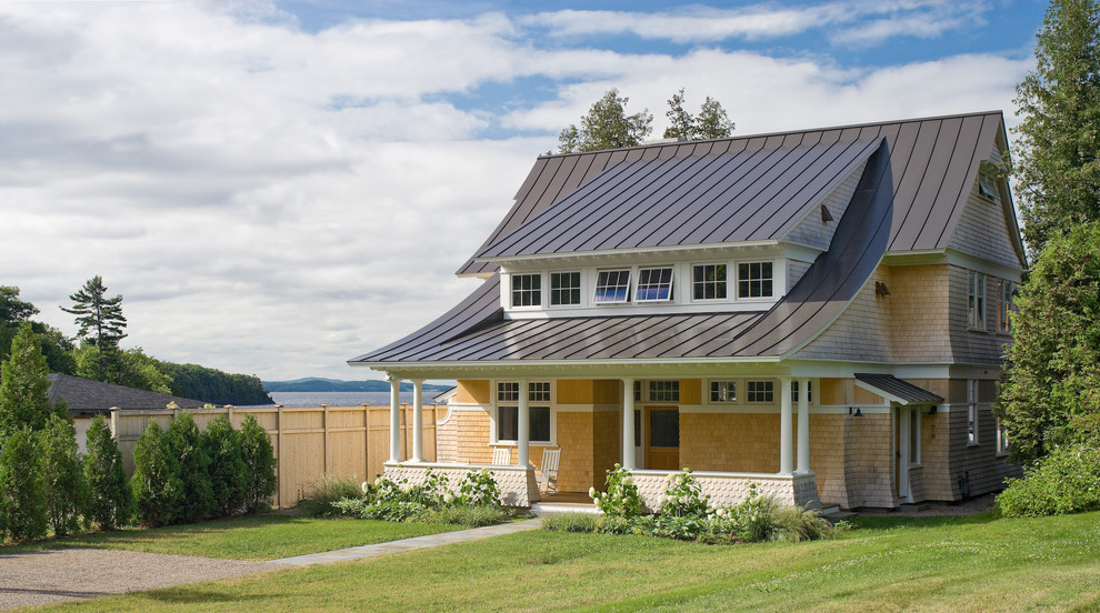 Design ideas for a large traditional two-storey house exterior in Burlington with wood siding.