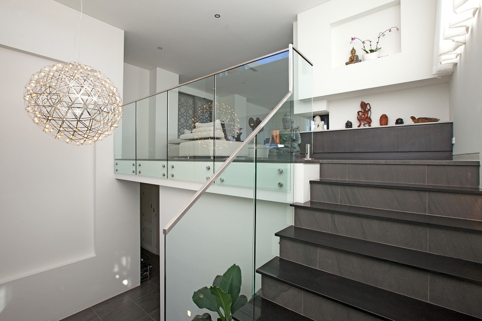 Mid-sized contemporary tile straight staircase in Sydney with tile risers.