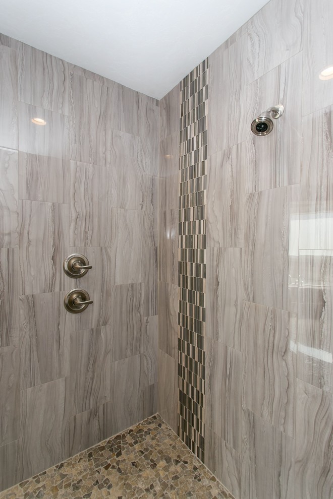 Corner bathtub - large transitional master gray tile and glass tile porcelain tile and gray floor corner bathtub idea in Seattle with shaker cabinets, dark wood cabinets, a two-piece toilet, gray walls, an undermount sink, quartz countertops and white countertops