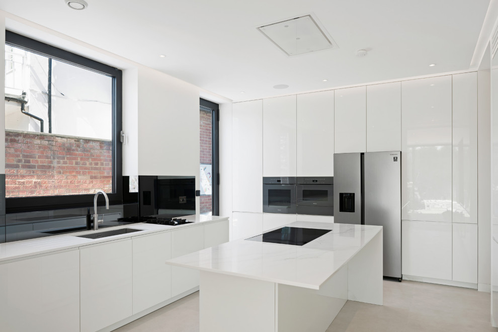 Medium sized modern u-shaped enclosed kitchen in London with flat-panel cabinets, white cabinets, quartz worktops, black splashback, glass sheet splashback, stainless steel appliances, porcelain flooring, an island, beige floors, white worktops, a coffered ceiling and feature lighting.