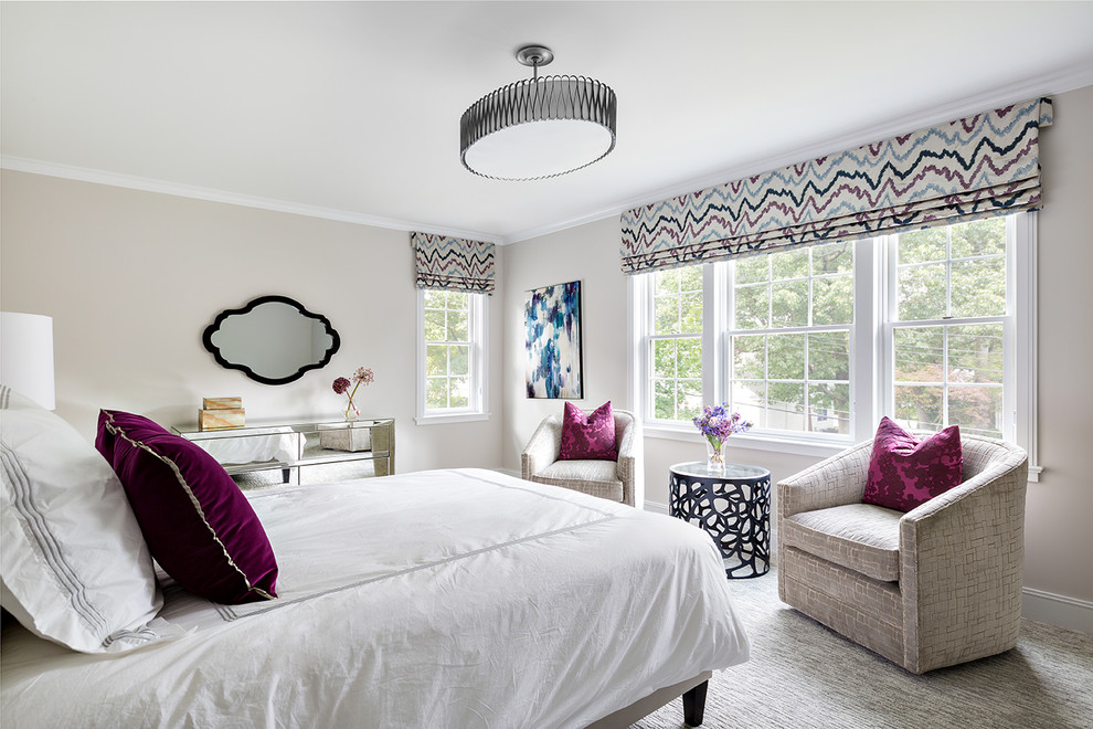 This is an example of a transitional bedroom in New York with beige walls and carpet.