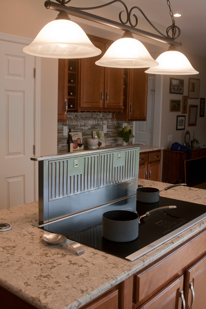 Inspiration for a mid-sized transitional l-shaped medium tone wood floor open concept kitchen remodel in DC Metro with a double-bowl sink, raised-panel cabinets, medium tone wood cabinets, granite countertops, brown backsplash, stainless steel appliances and matchstick tile backsplash