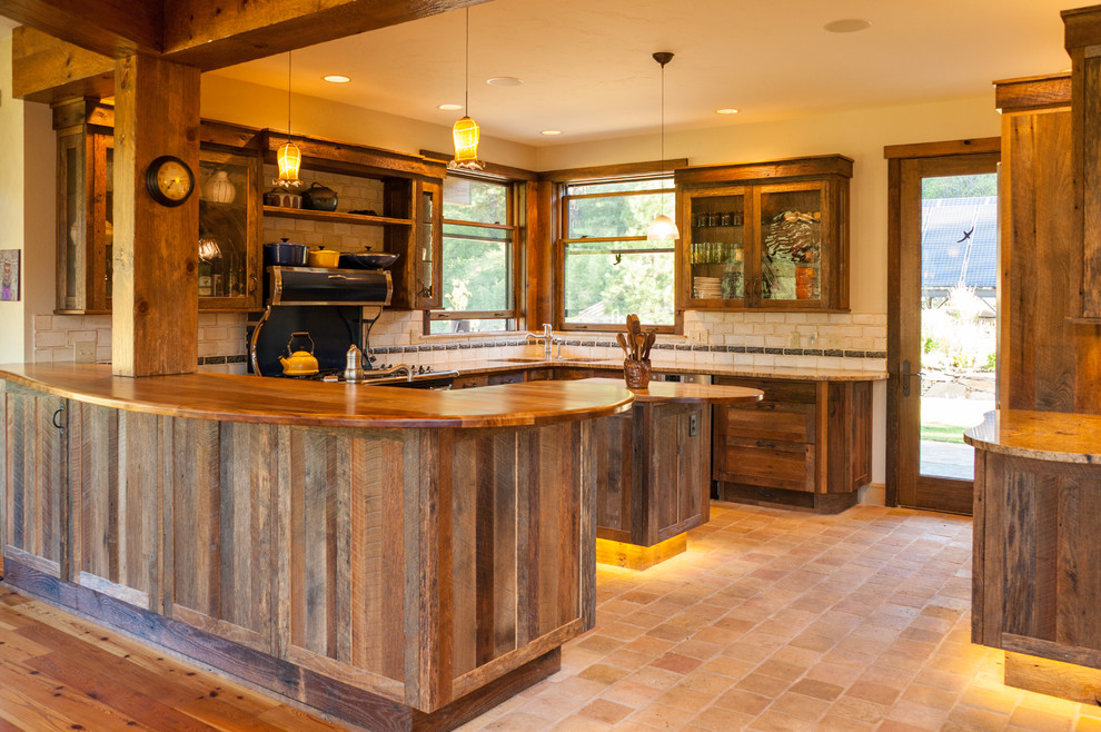 Large mountain style u-shaped cement tile floor and beige floor open concept kitchen photo in Seattle with recessed-panel cabinets, granite countertops, beige backsplash, ceramic backsplash, stainless steel appliances, an island, an undermount sink and dark wood cabinets