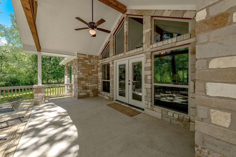Inspiration for a mid-sized transitional one-story and backyard stone beige deck remodel in Austin with a hip roof, a shingle roof and a roof extension
