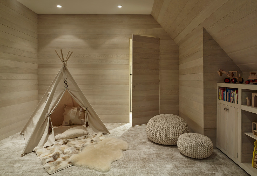 Mid-sized transitional gender-neutral kids' playroom in New York with beige walls, carpet and beige floor for kids 4-10 years old.