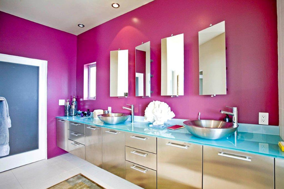 Large eclectic master bathroom in Los Angeles with flat-panel cabinets, pink walls, porcelain floors, a vessel sink, glass benchtops and grey floor.