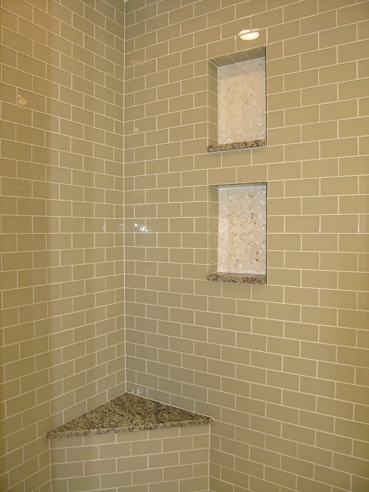 Design ideas for a large transitional master bathroom in Tampa with recessed-panel cabinets, black cabinets, a freestanding tub, an alcove shower, a one-piece toilet, beige tile, black tile, black and white tile, brown tile, gray tile, multi-coloured tile, white tile, mosaic tile, beige walls, travertine floors, an undermount sink and granite benchtops.