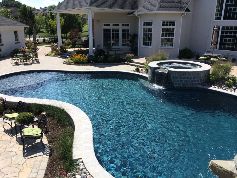 Large traditional backyard custom-shaped natural pool in Philadelphia with concrete pavers.