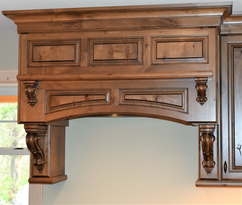 Example of a huge mountain style kitchen design with distressed cabinets