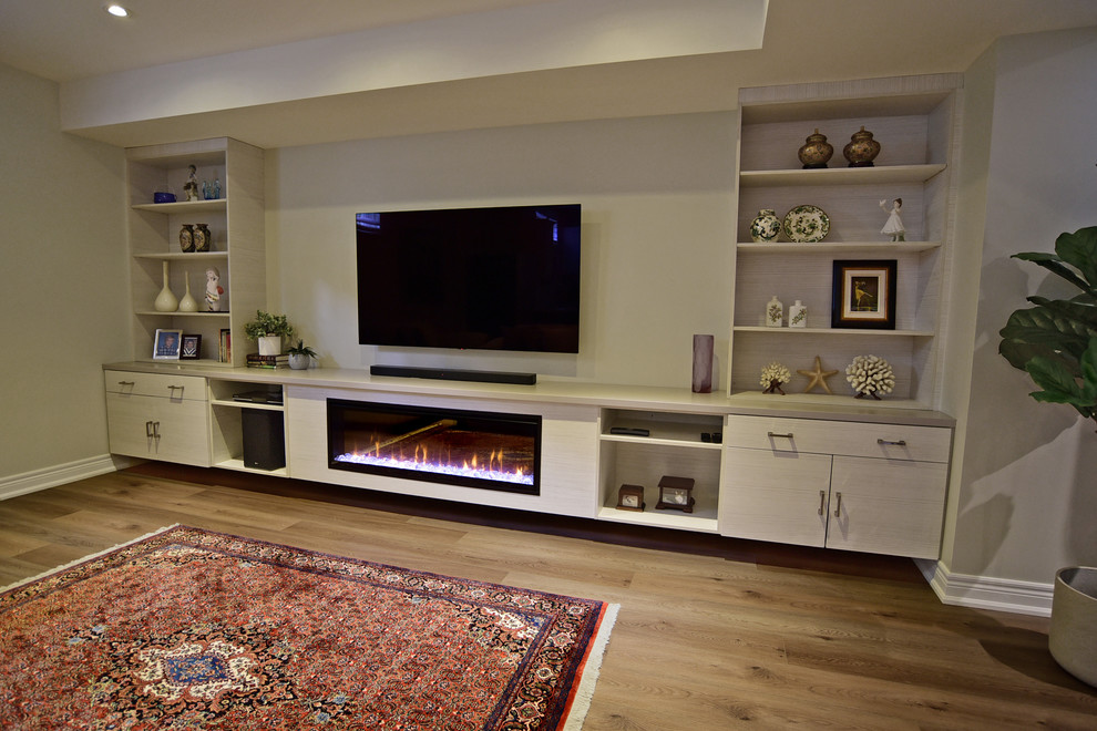 Photo of a transitional basement in Toronto with grey walls, vinyl floors, a standard fireplace, a wood fireplace surround and brown floor.