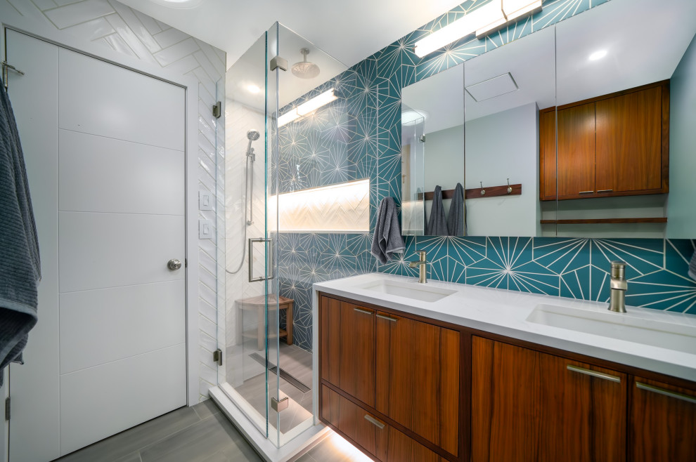 Modern bathroom in Other with dark wood cabinets, a one-piece toilet, blue tile, porcelain tile, white walls, porcelain floors, an undermount sink, quartzite benchtops, grey floor, a hinged shower door, white benchtops, a niche, a double vanity and a floating vanity.