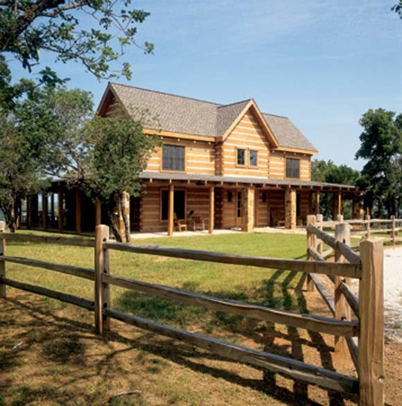 Inspiration for a large country two-storey brown exterior in Dallas with wood siding and a gable roof.