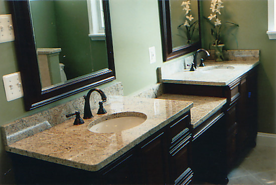 Inspiration for a mid-sized traditional master bathroom in St Louis with a drop-in sink, recessed-panel cabinets, black cabinets, granite benchtops, beige tile, ceramic tile, grey walls and ceramic floors.