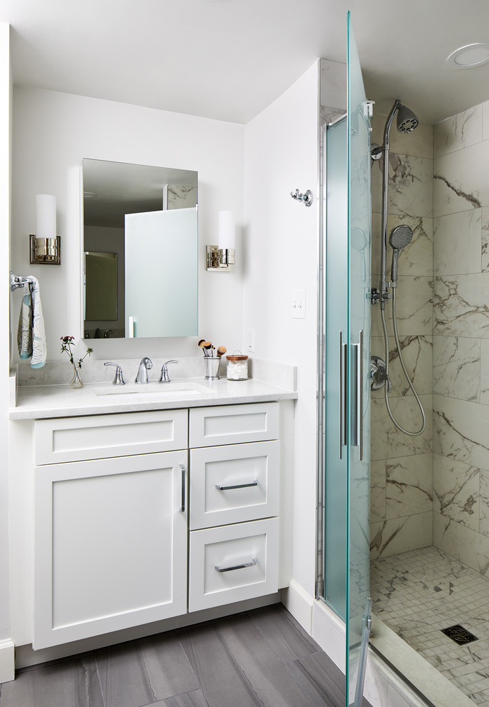 Small traditional 3/4 bathroom in DC Metro with white cabinets, a corner shower, shaker cabinets, multi-coloured tile, marble, white walls, an undermount sink, grey floor, a hinged shower door and white benchtops.