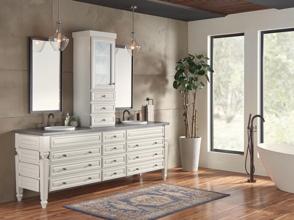 Freestanding bathtub - huge transitional master beige tile light wood floor and brown floor freestanding bathtub idea in Indianapolis with furniture-like cabinets, beige cabinets, beige walls, concrete countertops and gray countertops