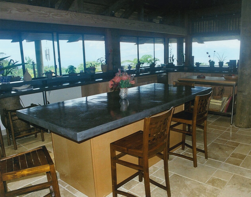 This is an example of a large tropical u-shaped separate kitchen in San Francisco with an undermount sink, flat-panel cabinets, light wood cabinets, concrete benchtops, multi-coloured splashback, mosaic tile splashback, stainless steel appliances, travertine floors and multiple islands.