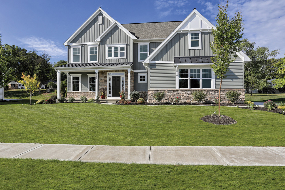 Example of a large transitional gray two-story exterior home design