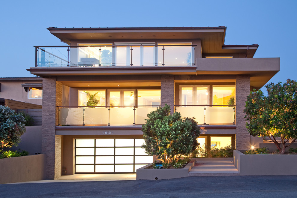 Large contemporary three-storey beige exterior in San Diego with mixed siding and a flat roof.