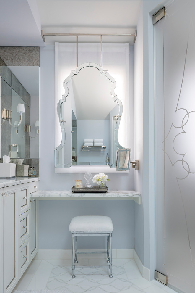 This is an example of a transitional master bathroom in Chicago with white cabinets and blue walls.