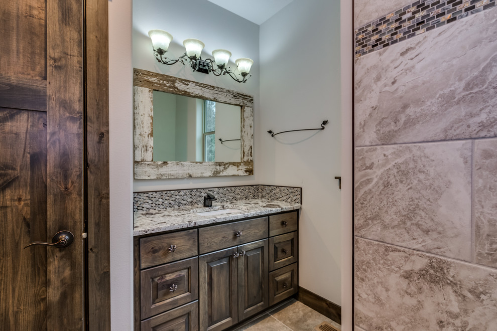 Example of a mid-sized mountain style beige tile and ceramic tile ceramic tile and beige floor doorless shower design with raised-panel cabinets, medium tone wood cabinets, an undermount sink and quartz countertops