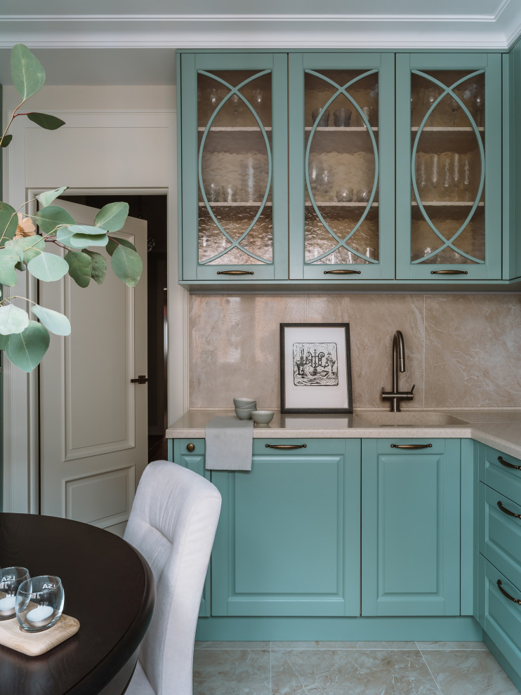 This is an example of a mid-sized transitional l-shaped eat-in kitchen in Moscow with an undermount sink, raised-panel cabinets, turquoise cabinets, solid surface benchtops, beige splashback, stainless steel appliances, ceramic floors, beige floor and beige benchtop.