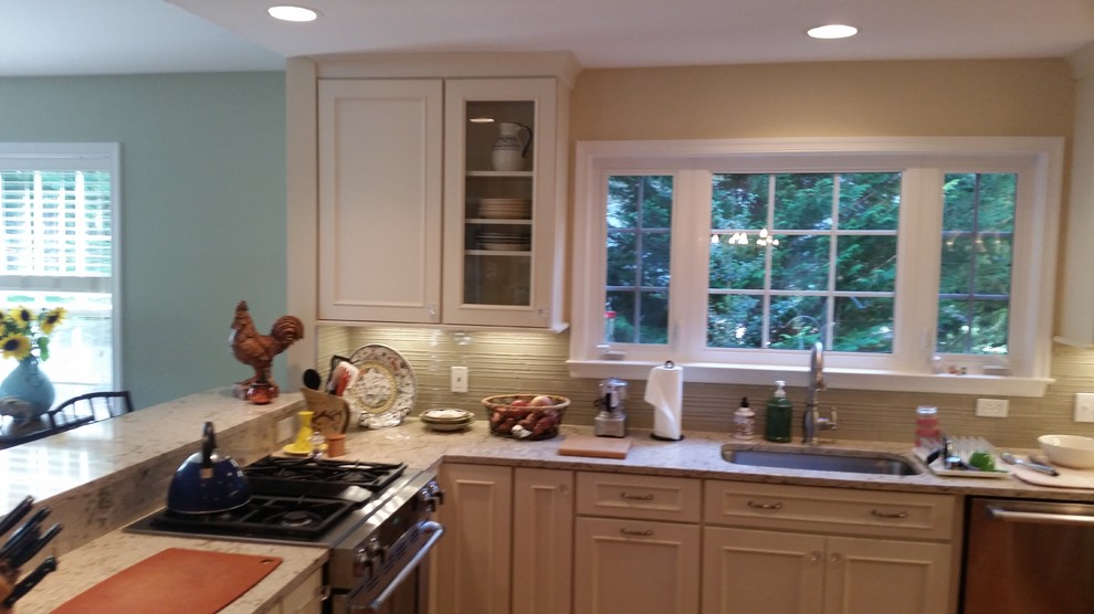Transitional kitchen photo with flat-panel cabinets, white cabinets, quartz countertops and glass sheet backsplash