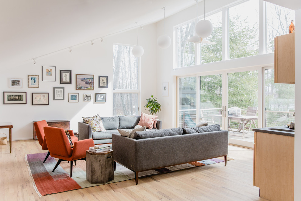 Inspiration for a large contemporary formal open concept living room in Portland Maine with white walls, light hardwood floors, beige floor, no fireplace and no tv.