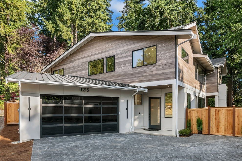 This is an example of a modern two-storey house exterior in Seattle with a metal roof and a black roof.