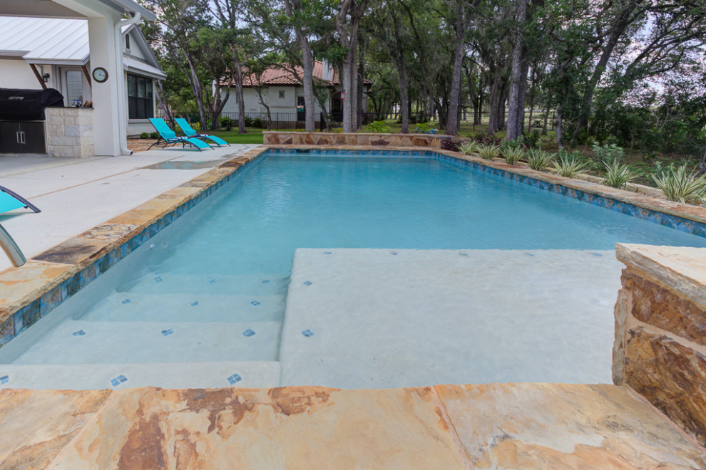 Example of a mid-sized transitional backyard rectangular natural hot tub design in Austin with decking