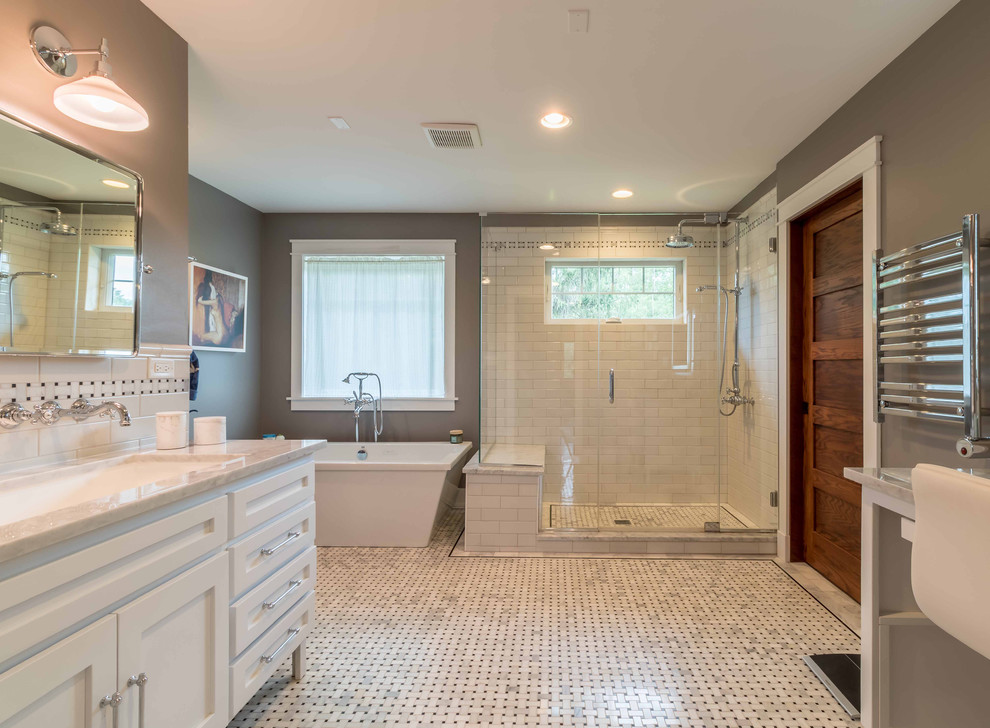 Mid-sized arts and crafts master bathroom in Chicago with shaker cabinets, white cabinets, a freestanding tub, a two-piece toilet, black and white tile, subway tile, grey walls, marble floors, an undermount sink, marble benchtops, white floor, a hinged shower door, white benchtops, a freestanding vanity, an alcove shower, a shower seat, a double vanity, wallpaper and decorative wall panelling.