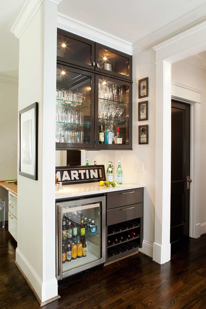 Inspiration for a mid-sized contemporary home bar in Atlanta with black cabinets, marble benchtops, mirror splashback, dark hardwood floors, white benchtop and glass-front cabinets.