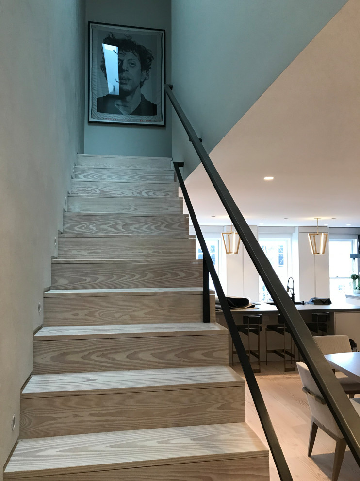 Design ideas for a large contemporary wood l-shaped staircase in DC Metro with wood risers and mixed railing.