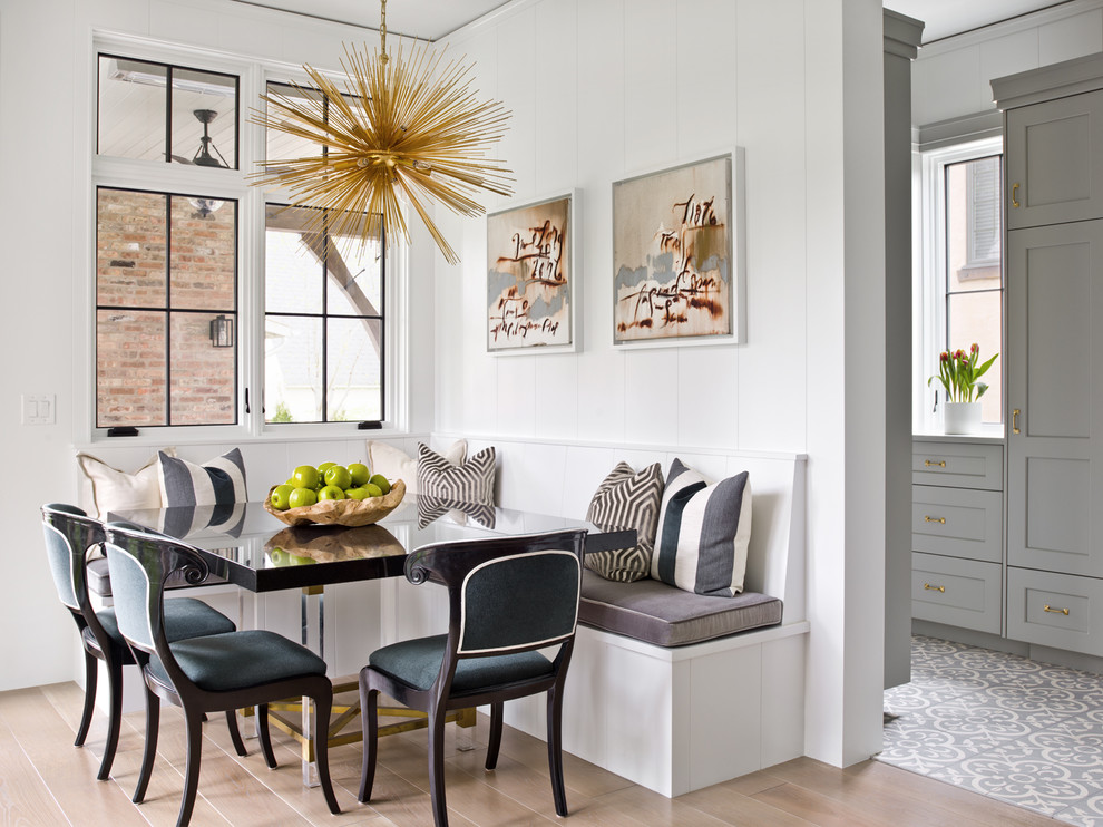 Inspiration for a country dining room in Chicago with white walls, medium hardwood floors and brown floor.