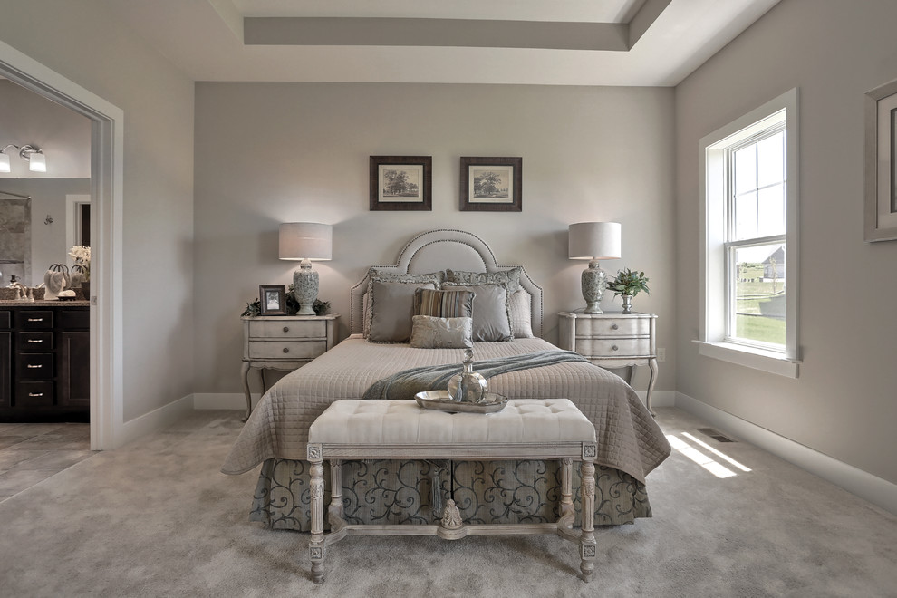 Large transitional master bedroom in Other with beige walls, carpet and beige floor.