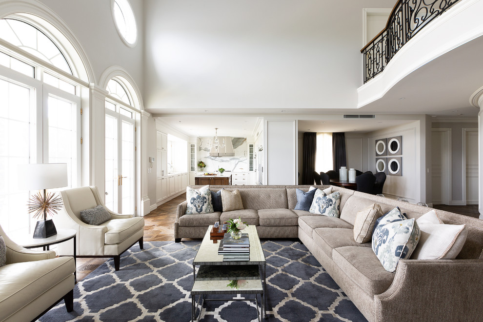 Transitional open concept living room in Sydney with white walls, medium hardwood floors and brown floor.