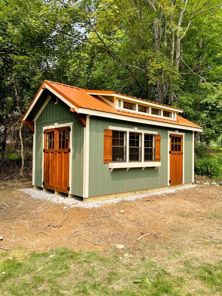 This is an example of a mid-sized traditional detached garden shed in Cleveland.