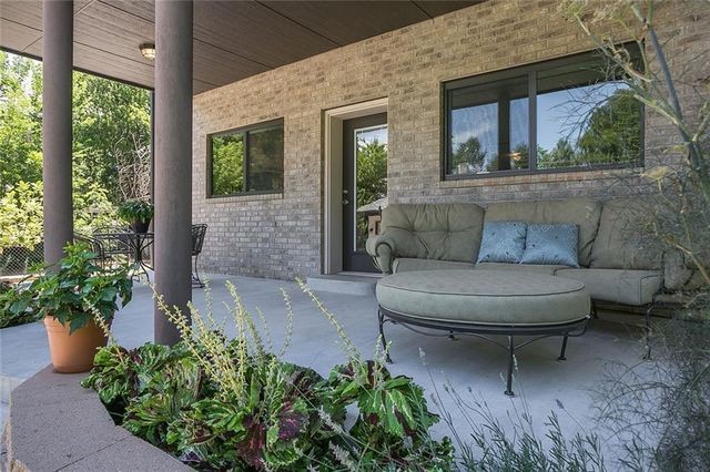 Inspiration for a mid-sized modern backyard patio in Oklahoma City with stamped concrete and a roof extension.
