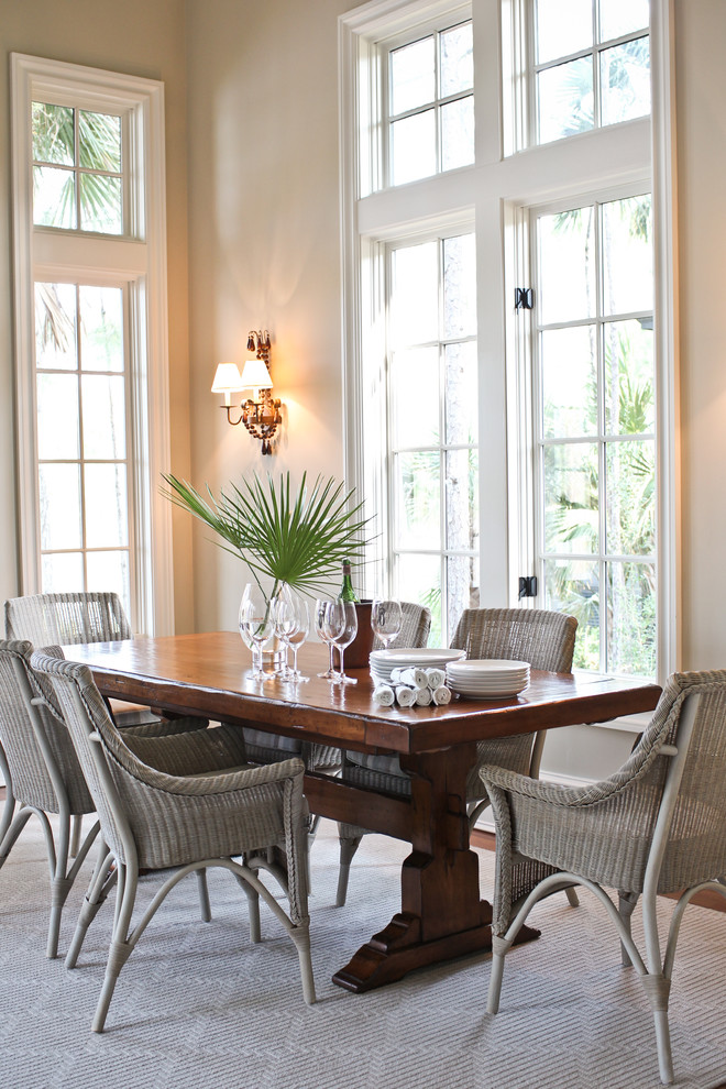 Inspiration for a beach style dining room in Charleston with beige walls and dark hardwood floors.