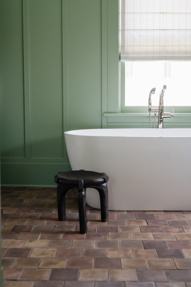 Photo of an arts and crafts master bathroom in Minneapolis with dark wood cabinets, a freestanding tub, white tile, ceramic tile, green walls, terra-cotta floors, an undermount sink, marble benchtops, multi-coloured floor and white benchtops.