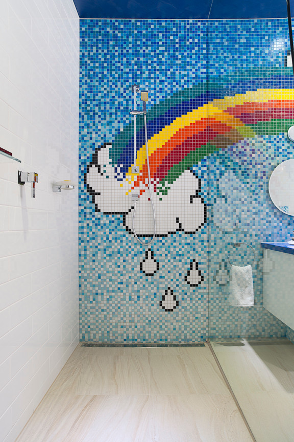 Photo of a large contemporary kids bathroom in Melbourne with flat-panel cabinets, white cabinets, solid surface benchtops and multi-coloured tile.