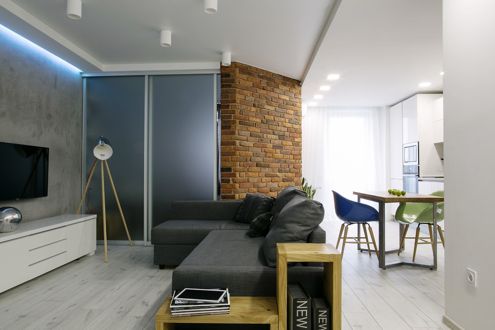 This is an example of a small contemporary formal open concept living room in Moscow with white walls and a wall-mounted tv.