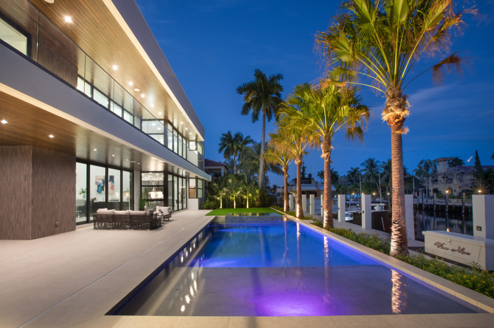 This is an example of an expansive modern backyard rectangular lap pool in Miami.