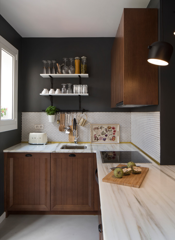 This is an example of a small scandinavian l-shaped kitchen in Barcelona with raised-panel cabinets, brown cabinets, marble benchtops, white splashback, mosaic tile splashback, no island and white floor.
