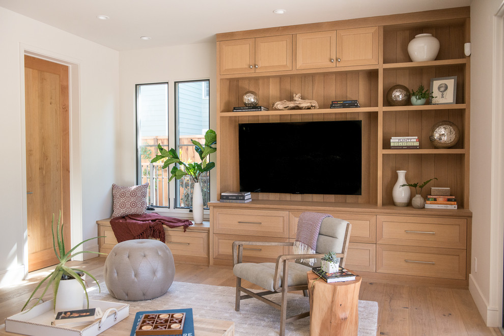 Design ideas for a large transitional family room in San Francisco with a library, white walls, light hardwood floors, no fireplace and a built-in media wall.