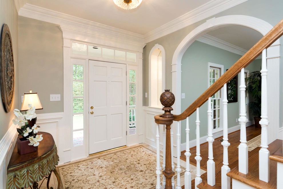 Photo of a small traditional foyer in Raleigh with beige walls, medium hardwood floors, a single front door, a white front door and brown floor.