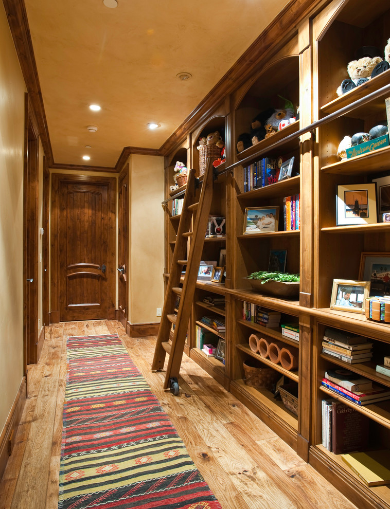 Hallway - mid-sized rustic medium tone wood floor and beige floor hallway idea in Denver with beige walls